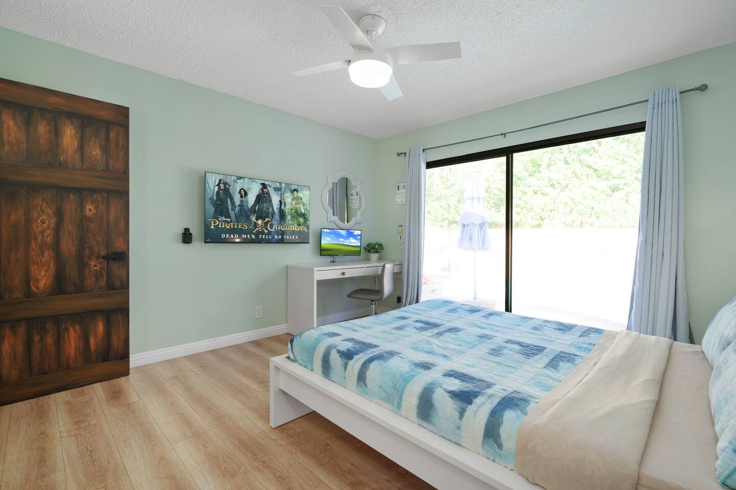 A king bed with a private workstation and a monitor you can plug any device into