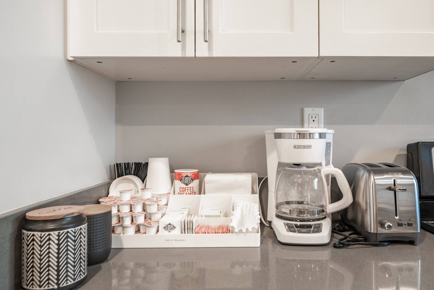 Coffeemaker and fully stocked accompaniments! 