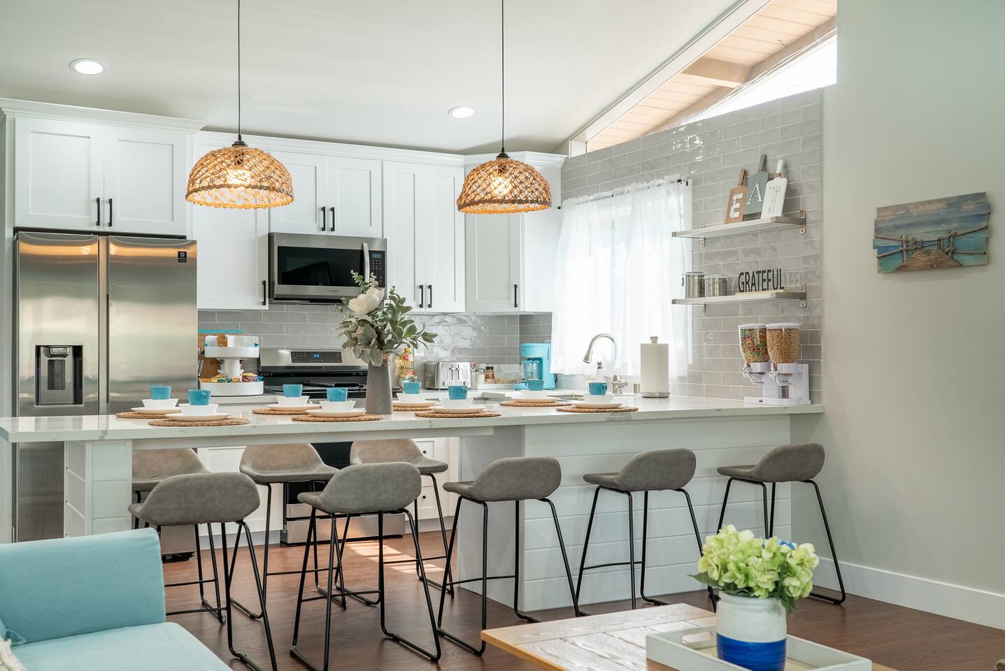 Airy kitchen with extended island and high chairs.