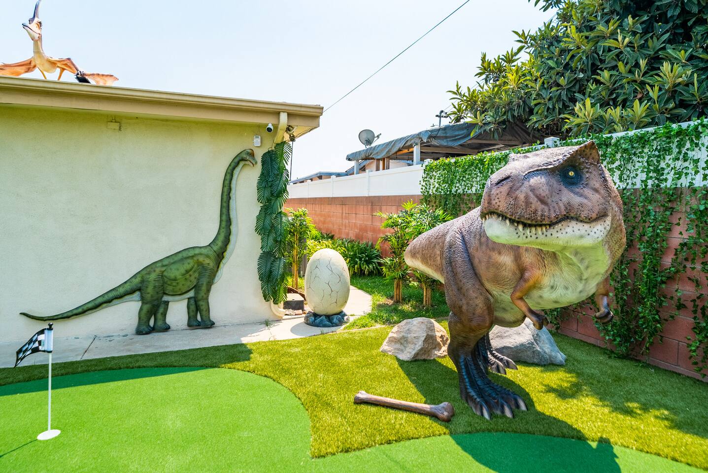 A baby T-Rex and gentle Brachiosaurus