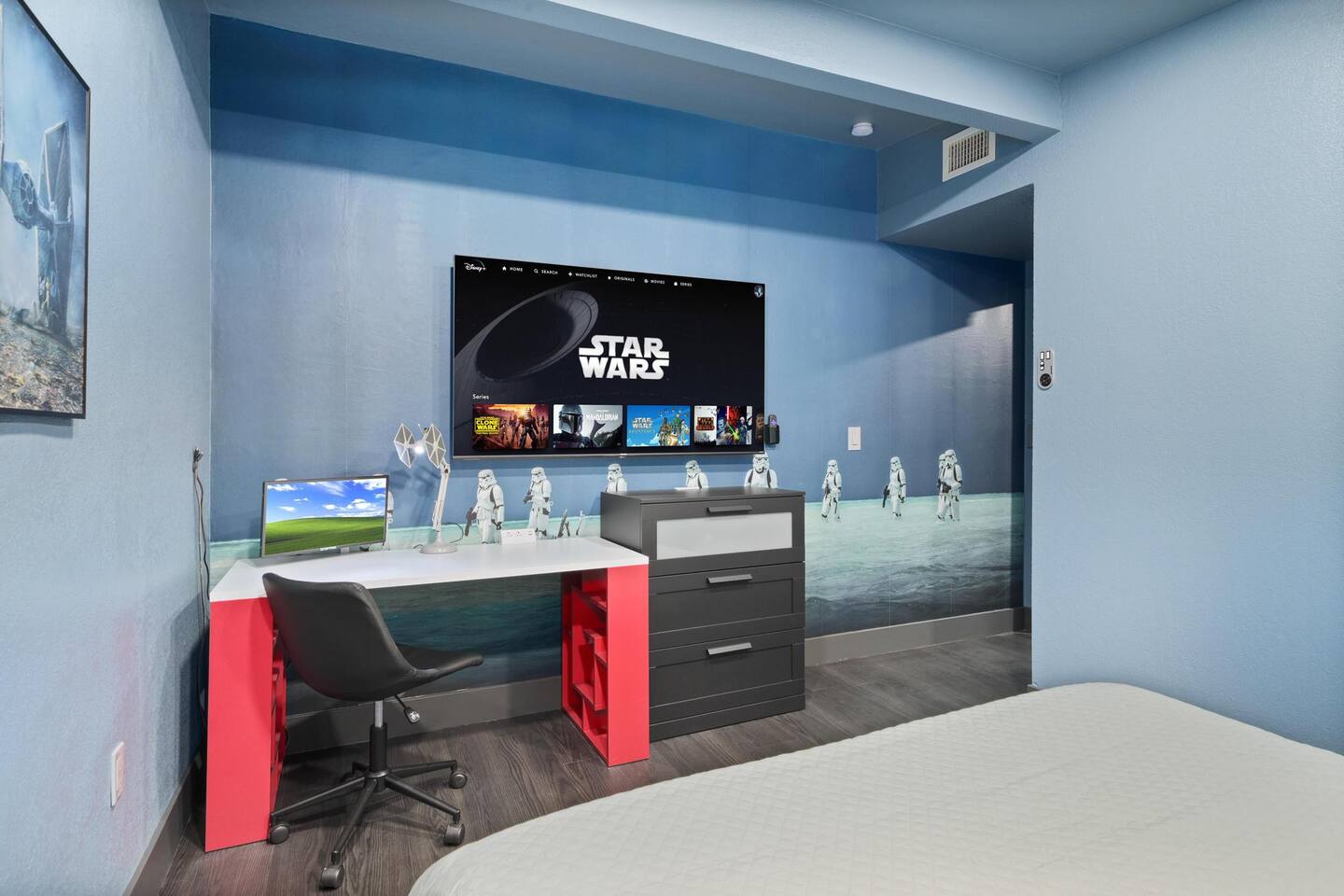Master bedroom includes a Roku tv and a desk for urgent calls from Darth Vader!